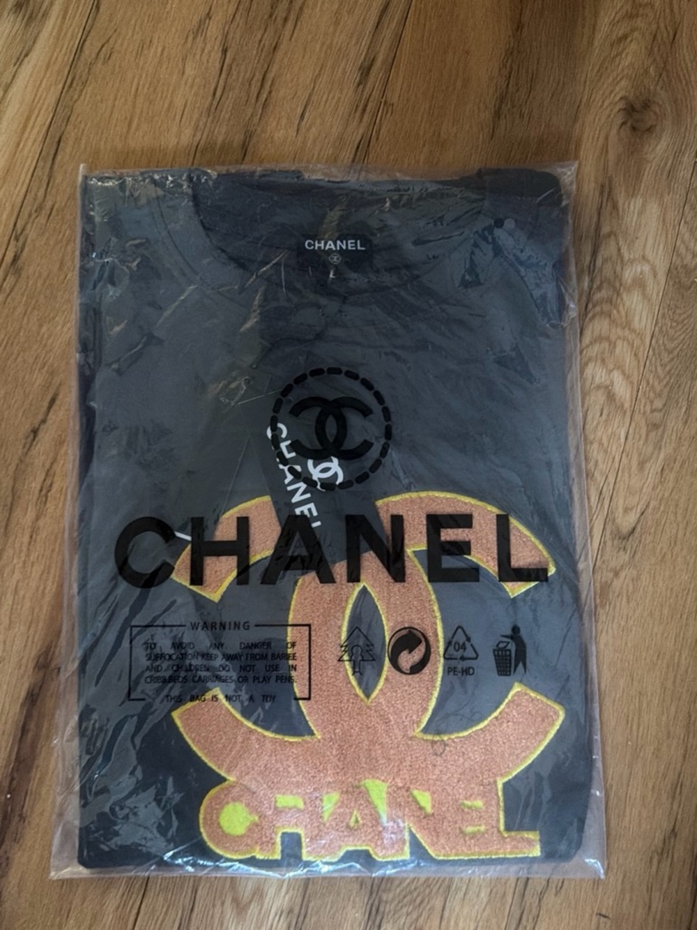 CHANEL Black Short Sleeve Tee with Gold and Pink Logo